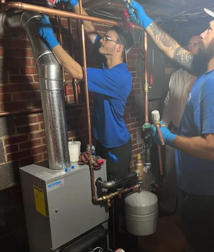 Leonard Splaine technicians piping in a new boiler