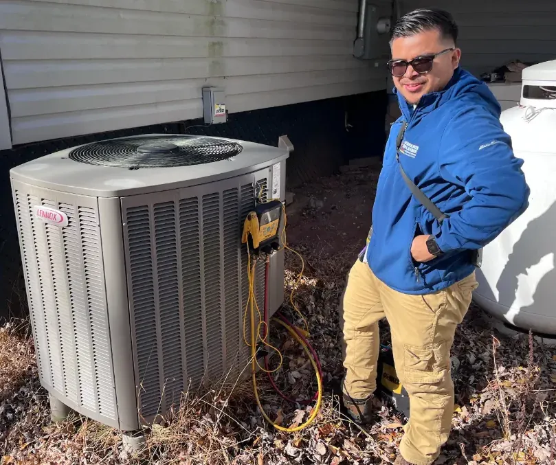 A Leonard Splaine technician on a Lennox air conditioner maintenance visit