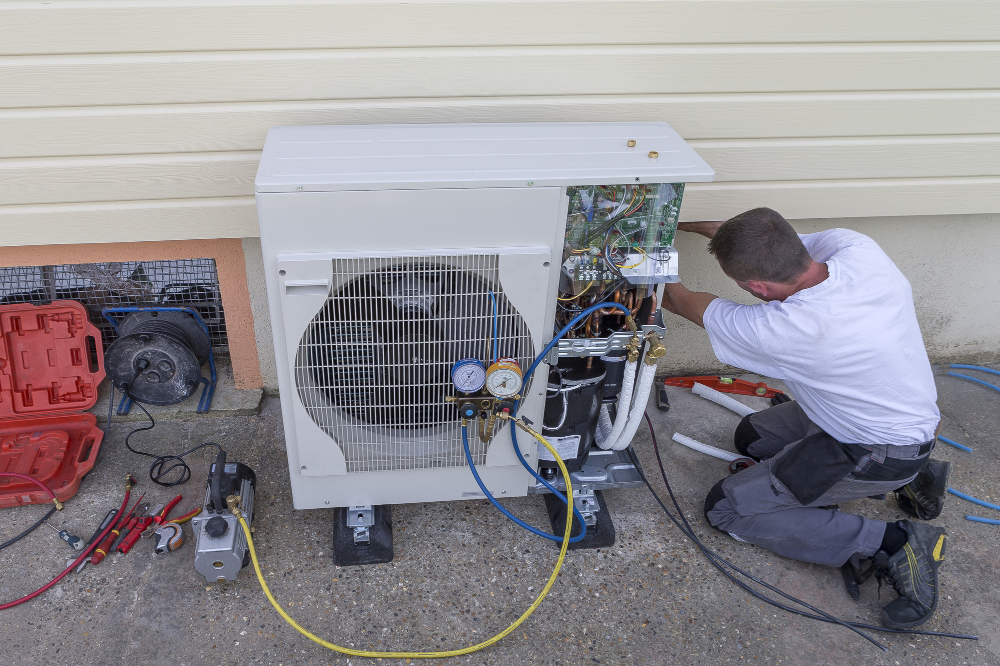 HVAC technician at work installing a circulation pump