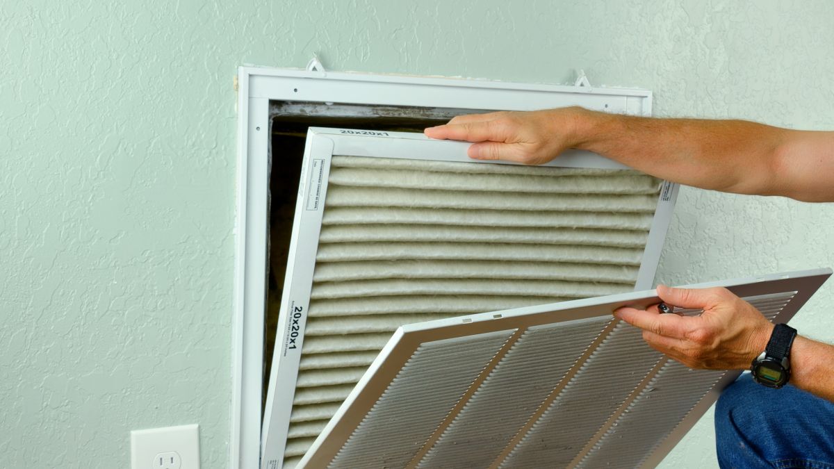Person replacing their air HVAC filter