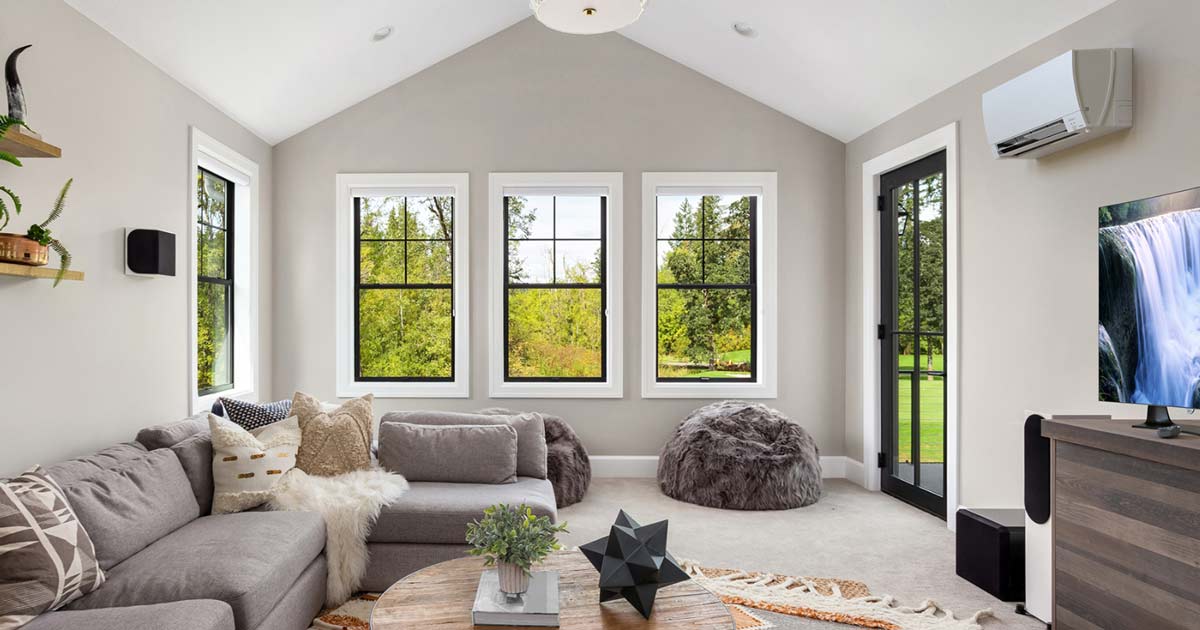 A living room with a mitsubishi mini split HVAC unit on the wall