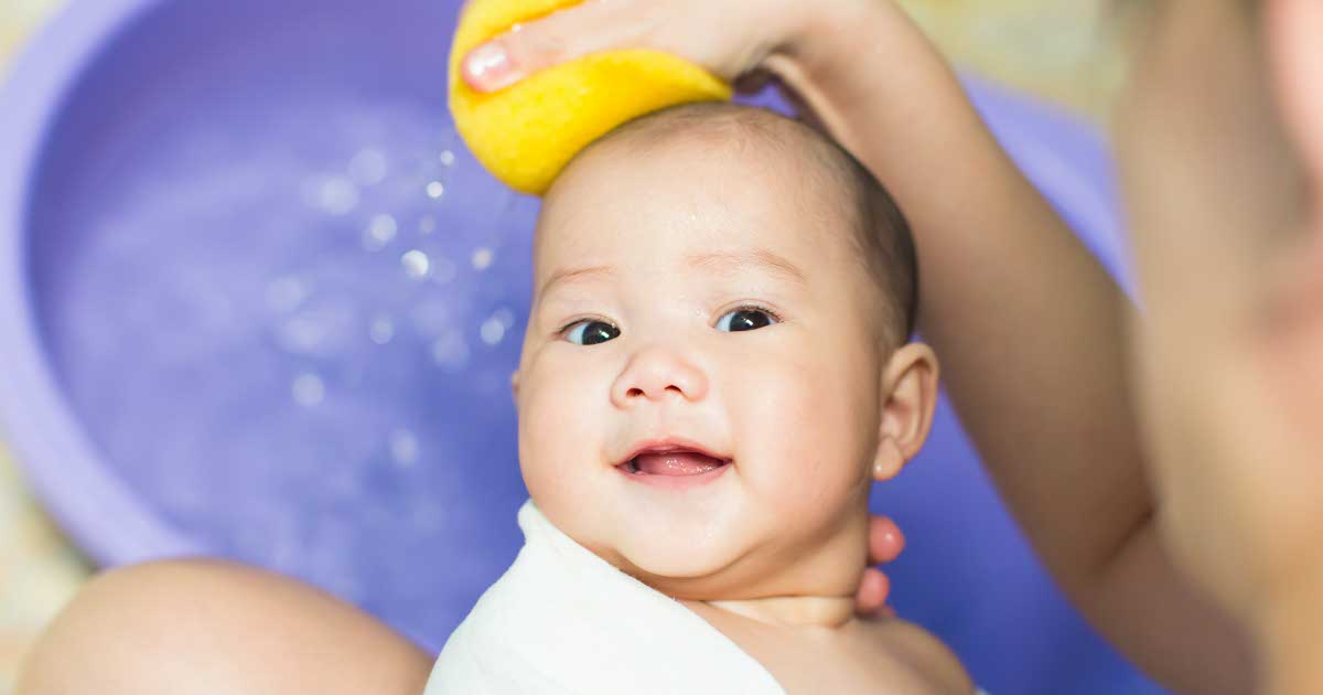 A baby bathing with her mother in the bathroom.