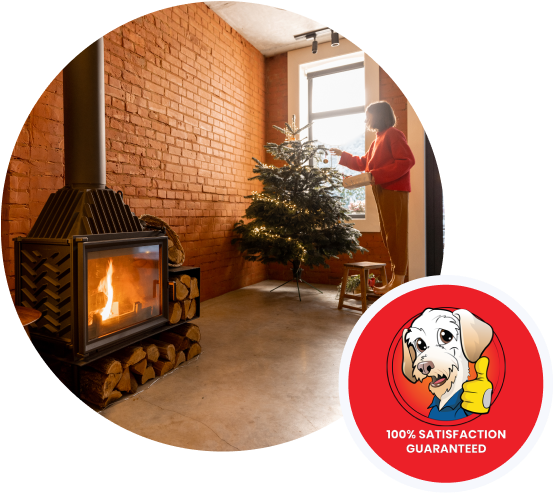 Modern wood stove fireplace heating a living room with a decorated Christmas tree.